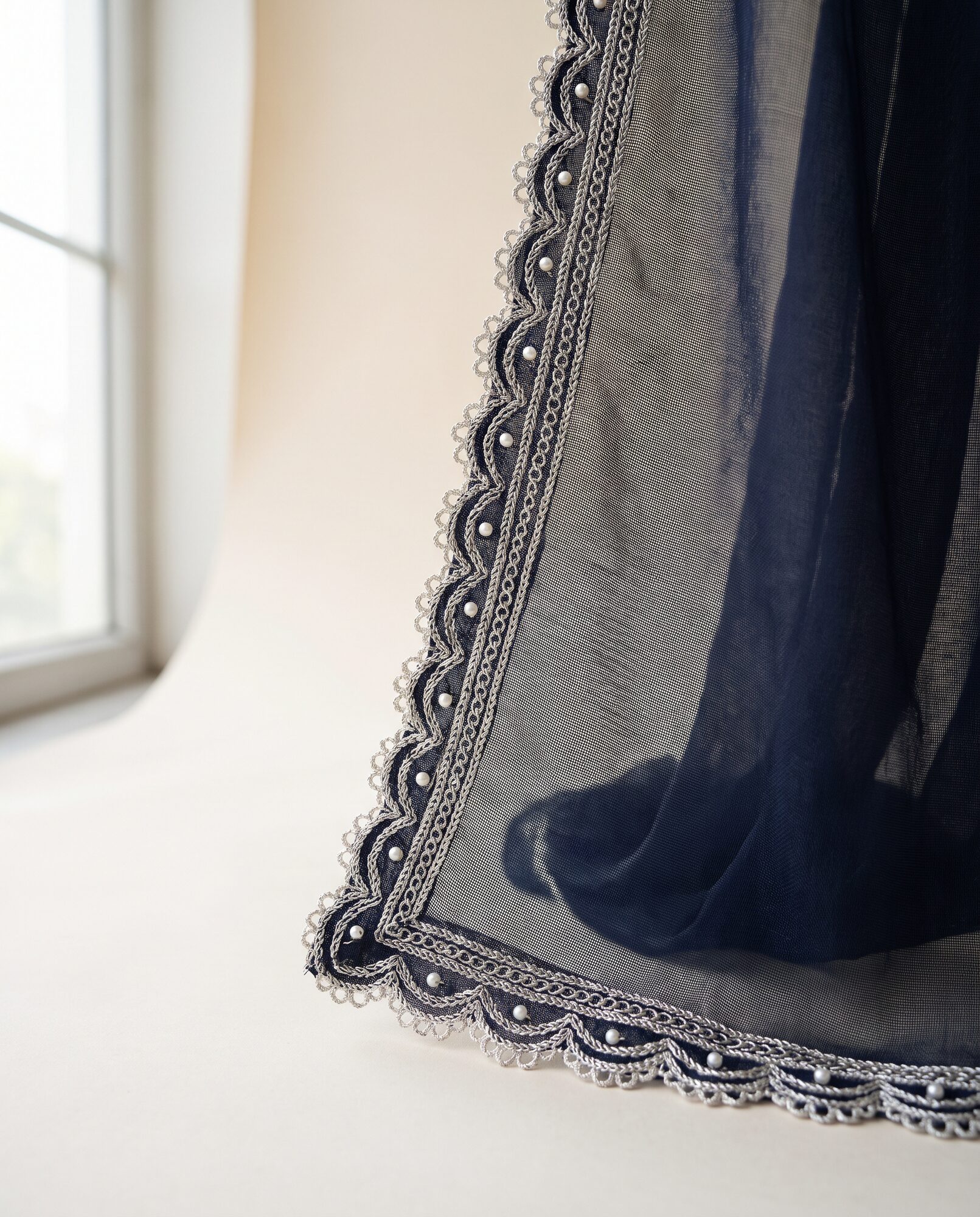 Close-up of the silver and pearl worked border on the midnight chiffon